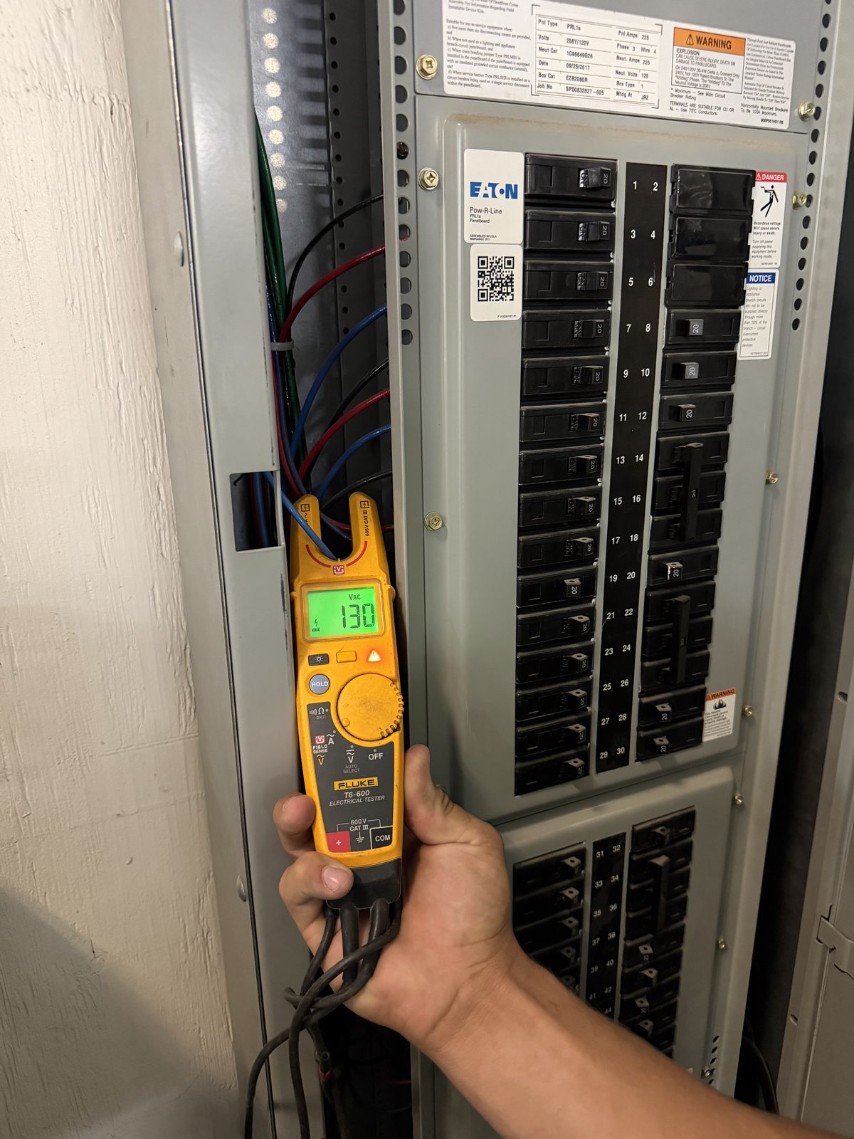 Technician performing condition assessment testing under an electrical maintenance program